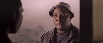 Movie still from “Tsotsi” (2005), directed by Gavin Hood – A person wearing a hat; Close Up shot, Low angle
