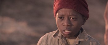 Movie still from “Tsotsi” (2005), directed by Gavin Hood – A person wearing a hat; Close Up shot, Low angle