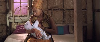 Movie still from “Tsotsi” (2005), directed by Gavin Hood – A woman holding a baby in her arms; Close Up shot, Low angle