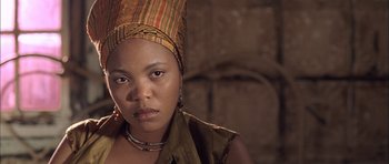 Movie still from “Tsotsi” (2005), directed by Gavin Hood – A person wearing a headdress; Close Up shot, Low angle