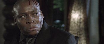 Movie still from “Tsotsi” (2005), directed by Gavin Hood – A person with blood on his face; Close Up shot, Low angle