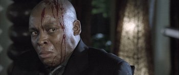 Movie still from “Tsotsi” (2005), directed by Gavin Hood – A man with blood all over his face and head; Close Up shot, Low angle