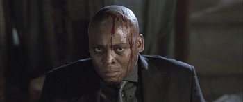 Movie still from “Tsotsi” (2005), directed by Gavin Hood – A person with blood on his face; Close Up shot, Low angle