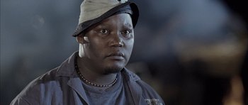 Movie still from “Tsotsi” (2005), directed by Gavin Hood – A person wearing a hat; Close Up shot, Low angle
