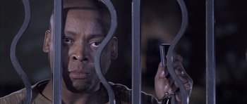 Movie still from “Tsotsi” (2005), directed by Gavin Hood – A person holding a cell phone; Close Up shot, Low angle