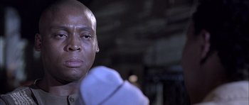 Movie still from “Tsotsi” (2005), directed by Gavin Hood – A man's face in a boxing ring; Close Up shot, Low angle