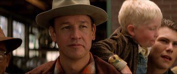 Movie still from “Tucker: The Man and His Dream” (1988), directed by Francis Ford Coppola – A person wearing a hat; Close Up shot, Over the shoulder angle