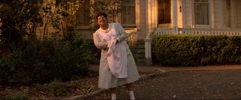 Movie still from “Tucker: The Man and His Dream” (1988), directed by Francis Ford Coppola – A woman holding a baby in front of a house; Wide shot, Low angle