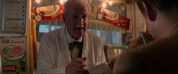 Movie still from “Tucker: The Man and His Dream” (1988), directed by Francis Ford Coppola – An old man in a white suit is smoking a cigarette; Close Up shot, Low angle
