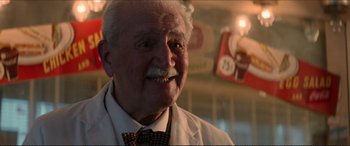 Movie still from “Tucker: The Man and His Dream” (1988), directed by Francis Ford Coppola – An old man with a mustache and a tie is smiling for the camera; Close Up shot, Low angle