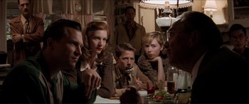 Movie still from “Tucker: The Man and His Dream” (1988), directed by Francis Ford Coppola – A group of people sitting around a table; Medium shot, Over the shoulder angle