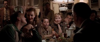 Movie still from “Tucker: The Man and His Dream” (1988), directed by Francis Ford Coppola – A group of people sitting at a table with food on it; Medium shot, Low angle