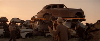 Movie still from “Tucker: The Man and His Dream” (1988), directed by Francis Ford Coppola – Two men are looking at an old car; Wide shot, Low angle