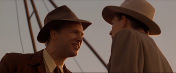 Movie still from “Tucker: The Man and His Dream” (1988), directed by Francis Ford Coppola – A man in a suit and hat talking to another man in a suit and hat; Close Up shot, Over the shoulder angle