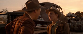 Movie still from “Tucker: The Man and His Dream” (1988), directed by Francis Ford Coppola – Two men talking to each other in front of an airplane; Medium shot, Over the shoulder angle