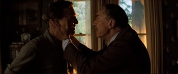 Movie still from “Tucker: The Man and His Dream” (1988), directed by Francis Ford Coppola – A man touching another man's face with his hands; Close Up shot, Over the shoulder angle