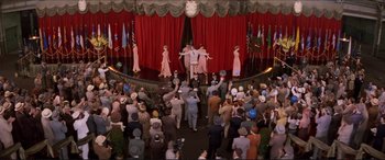 Movie still from “Tucker: The Man and His Dream” (1988), directed by Francis Ford Coppola – A crowd of people are gathered in front of a stage; Extreme Wide shot, High angle