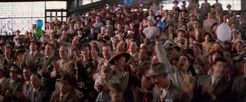 Movie still from “Tucker: The Man and His Dream” (1988), directed by Francis Ford Coppola – A crowd of people in a stadium with hats on; Wide shot, High angle