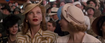 Movie still from “Tucker: The Man and His Dream” (1988), directed by Francis Ford Coppola – Two women wearing hats and one of them has red lipstick on her lips; Close Up shot, Low angle