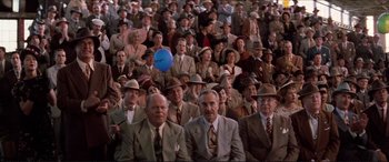 Movie still from “Tucker: The Man and His Dream” (1988), directed by Francis Ford Coppola – A crowd of people in suits and hats are sitting; Wide shot, High angle