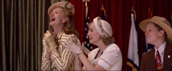 Movie still from “Tucker: The Man and His Dream” (1988), directed by Francis Ford Coppola – A couple of people that are laughing together; Medium shot, Low angle