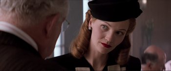 Movie still from “Tucker: The Man and His Dream” (1988), directed by Francis Ford Coppola – A person wearing a hat; Close Up shot, Over the shoulder angle