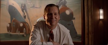 Movie still from “Tucker: The Man and His Dream” (1988), directed by Francis Ford Coppola – A man in a white shirt and a red neck tie; Close Up shot, Low angle