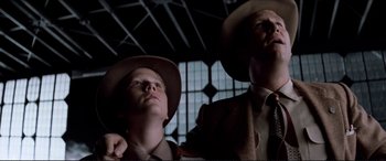 Movie still from “Tucker: The Man and His Dream” (1988), directed by Francis Ford Coppola – Two men wearing hats looking up at the sky; Medium shot, Low angle