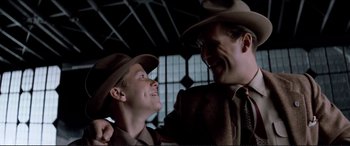 Movie still from “Tucker: The Man and His Dream” (1988), directed by Francis Ford Coppola – A man and a man in a suit and hat; Medium shot, Low angle