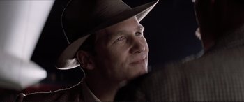 Movie still from “Tucker: The Man and His Dream” (1988), directed by Francis Ford Coppola – A person wearing a hat; Close Up shot, Over the shoulder angle