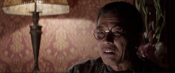 Movie still from “Tucker: The Man and His Dream” (1988), directed by Francis Ford Coppola – An older man wearing glasses sitting in front of a wall; Close Up shot, Low angle