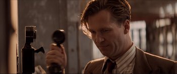 Movie still from “Tucker: The Man and His Dream” (1988), directed by Francis Ford Coppola – A person holding a hair brush; Close Up shot, Low angle