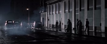 Movie still from “Tucker: The Man and His Dream” (1988), directed by Francis Ford Coppola – A group of men standing next to each other on a street; Extreme Wide shot, High angle