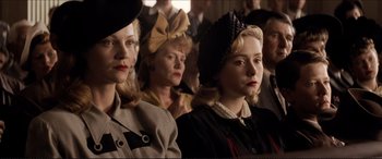 Movie still from “Tucker: The Man and His Dream” (1988), directed by Francis Ford Coppola – A group of people sitting in a room with hats on; Close Up shot, Low angle