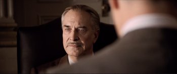 Movie still from “Tucker: The Man and His Dream” (1988), directed by Francis Ford Coppola – An older man looking at himself in the mirror; Close Up shot, Over the shoulder angle