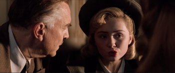 Movie still from “Tucker: The Man and His Dream” (1988), directed by Francis Ford Coppola – An older man and a young woman looking at each other; Close Up shot, Low angle