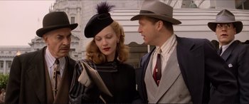 Movie still from “Tucker: The Man and His Dream” (1988), directed by Francis Ford Coppola – A man and a woman looking at a newspaper; Medium shot, Low angle