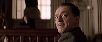 Movie still from “Tucker: The Man and His Dream” (1988), directed by Francis Ford Coppola – An older man in a courtroom with his eyes wide open; Close Up shot, Low angle