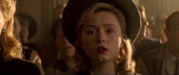 Movie still from “Tucker: The Man and His Dream” (1988), directed by Francis Ford Coppola – A woman with a hat and lipstick on her lips; Close Up shot, Low angle