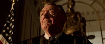 Movie still from “Tucker: The Man and His Dream” (1988), directed by Francis Ford Coppola – An older man wearing a suit and tie looking upward; Close Up shot, Low angle