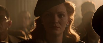 Movie still from “Tucker: The Man and His Dream” (1988), directed by Francis Ford Coppola – A person wearing a hat and looking sad; Close Up shot, Low angle