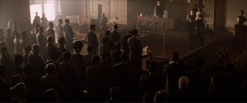 Movie still from “Tucker: The Man and His Dream” (1988), directed by Francis Ford Coppola – A group of people standing in front of a court room; Extreme Wide shot, High angle