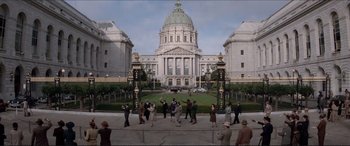 Movie still from “Tucker: The Man and His Dream” (1988), directed by Francis Ford Coppola – A group of people standing in front of a large building; Extreme Wide shot, High angle
