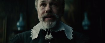 Movie still from “Tulip Fever” (2017), directed by Justin Chadwick – An old man with a beard and a white collar; Close Up shot, Low angle