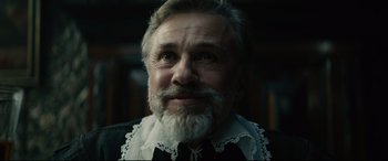 Movie still from “Tulip Fever” (2017), directed by Justin Chadwick – An older man with a beard and a white shirt; Close Up shot, Low angle