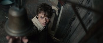 Movie still from “Tulip Fever” (2017), directed by Justin Chadwick – A young man is standing in a dark room; Close Up shot, High angle