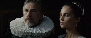 Movie still from “Tulip Fever” (2017), directed by Justin Chadwick – A man and a woman wearing a white paper collar; Close Up shot, Over the shoulder angle