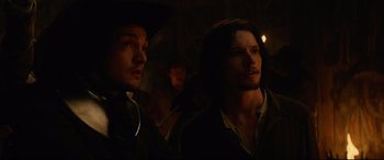 Movie still from “Tulip Fever” (2017), directed by Justin Chadwick – A group of men standing next to each other in the dark; Close Up shot, Low angle