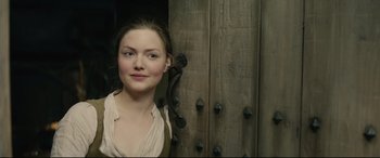 Movie still from “Tulip Fever” (2017), directed by Justin Chadwick – A woman standing in front of a wooden door; Close Up shot, Over the shoulder angle