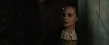 Movie still from “Tulip Fever” (2017), directed by Justin Chadwick – A woman in a white blouse and a black jacket; Close Up shot, Over the shoulder angle